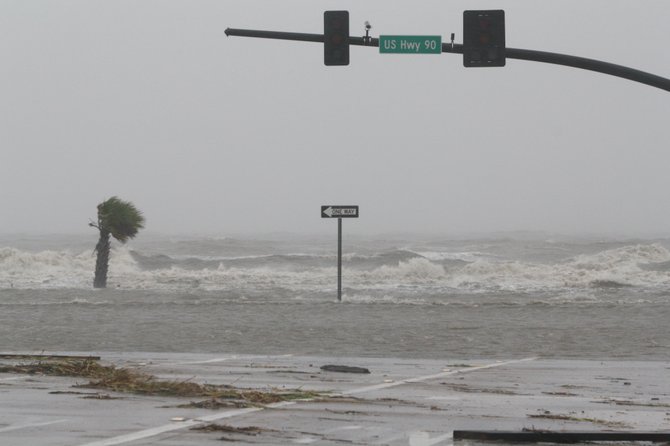 Gulf waters flood a portion of Highway 90 in Biloxi late Wednesday morning. 