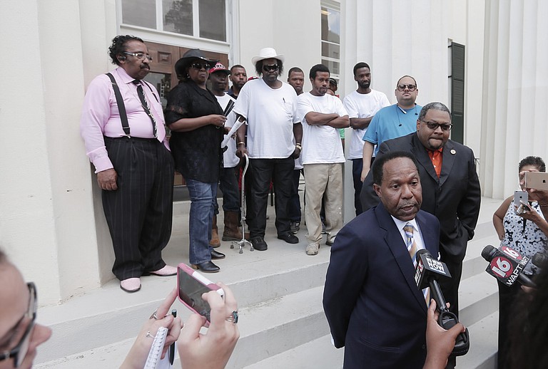 Attorney Robert Gibbs and his client Marcus Wallace of MAC & Associates address reporters outside Jackson City Hall soon after filing their lawsuit against Siemens in Hinds County Circuit Court.