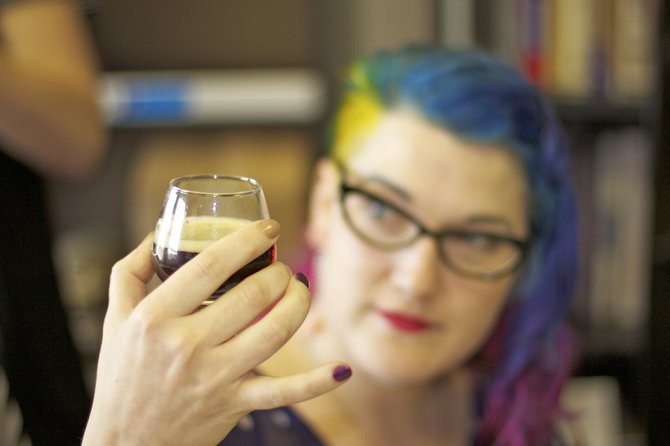 JFP Art Director Kristin Brenemen tries a new craft beer at the JFP vs. Raise Your Pints taste-off this summer.