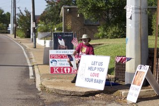 Protesters gathered outside the Jackson Women's Health Organization this morning after a federal judge moved last night to keep the clinic open at least 10 more days. Seated is Roy McMillan, husband of Pro-Life Mississippi President Beverly McMillan. The couple is also against birth control including the pill and the morning-after pill.