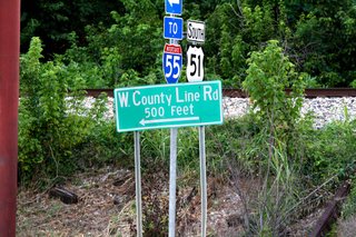 The city plans to connect East County Line and West County Line roads, separated by an approximately 100-yard gap and a railroad.