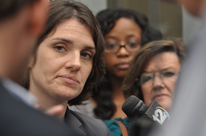 Clinic lawyer Michelle Movahed answers questions in front of the courthouse.