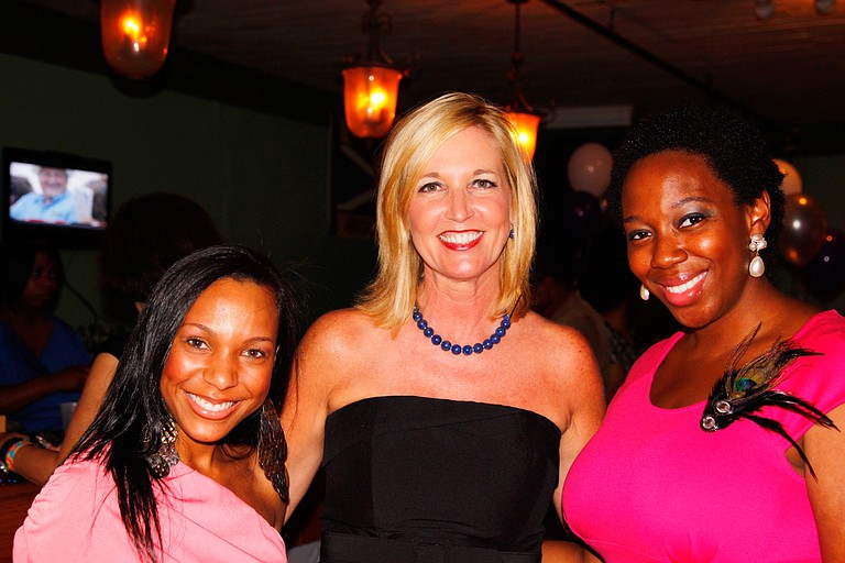 Center for Violence Prevention Director Sandy Middleton (center) enjoys the JFP Chick Ball with two attendees.