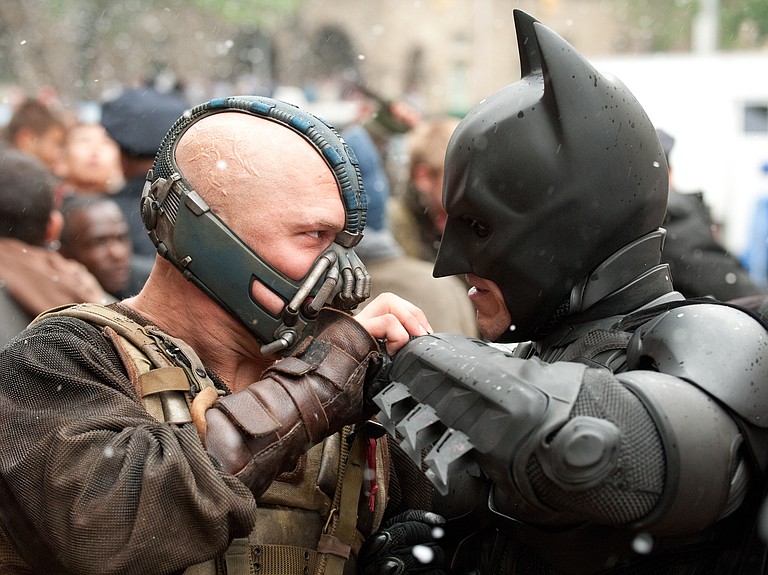 Batman's new nemesis, Bane (Tom Hardy), challenges the caped crusader (Christian Bale, right) in "The Dark Knight Rises."
