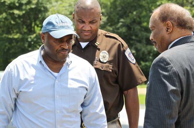 Hinds County Sheriff Tyrone Lewis (left) speaks to Hinds County Supervisor Robert Graham (right), District 1, outside the Hinds County Correctional Facility Monday. Inmates took over at least one housing unit of the jail Monday morning.