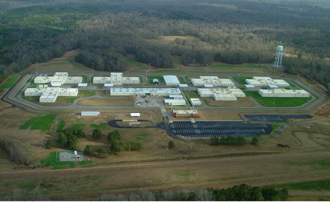 A Federal Bureau of Investigations report about the cause of a May riot at a privately run federal prison in Natchez refutes initial reports that a gang fight sparked the melee.