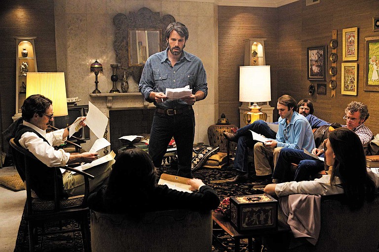 Ben Affleck (center) directed and stars in "Argo" which weaves together espionage, Hollywood mystique and '70s flair.
