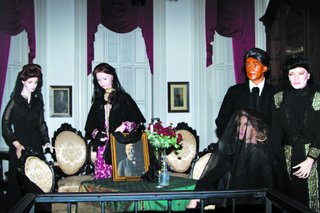 Antique dolls stand vigil in Merrehope Mansion in Meridian.
