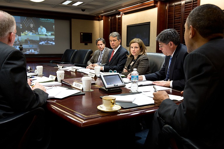 President Obama and his staff work together to help solve the problems that Hurricane Sandy has caused in the Northeastern portion of the United States. Here, they are being briefed by FEMA.