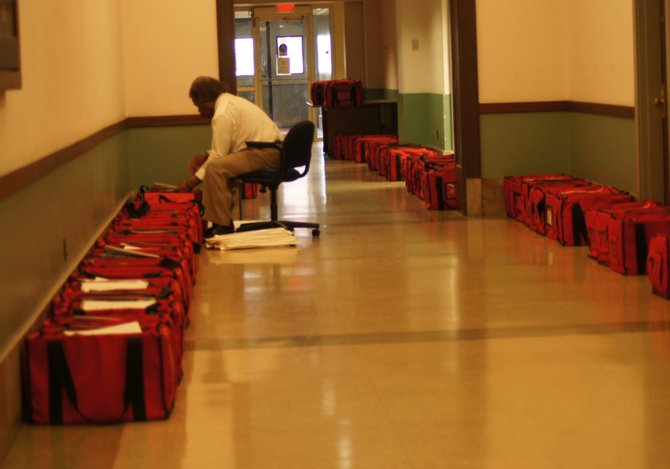 Hinds County Elections Commission Chairman Jermal Clark prepares for tomorrow's general election.