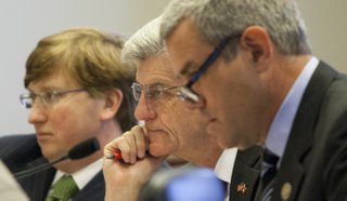 Gov. Phil Bryant, center, Lt. Gov. Tate Reeves, left, and state Speaker of the House Philip Gunn, right, received the good news that the state's revenues will increase by about $118 million more this year than originally expected.