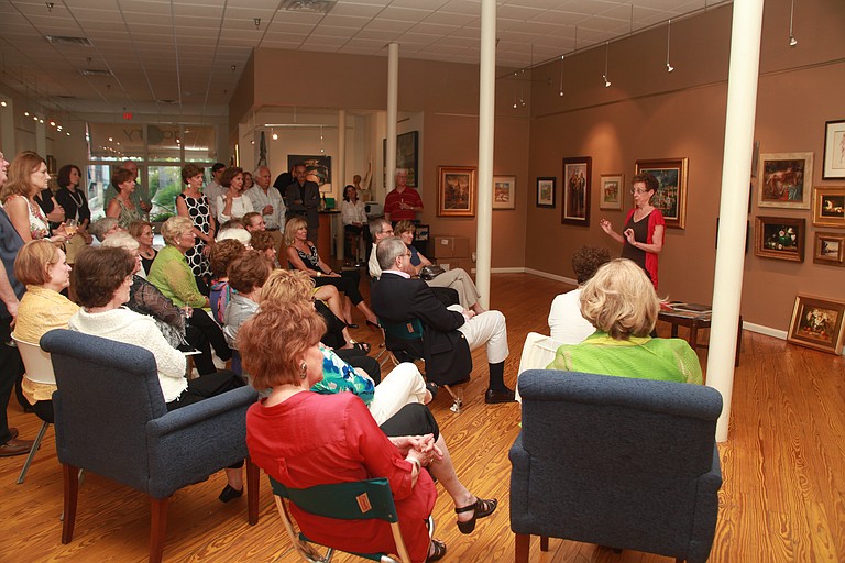 Artist Lucy Mazzaferro speaks to members of the New Collector’s Club during a gathering at Nunnery’s at Gallery 119.
