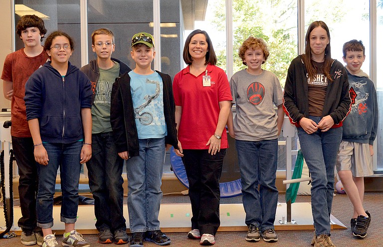 The Techno Warriors visited Methodist Rehab’s Outpatient Therapy Center in November. Pictured, from left, are Camden Blackburn, 13, of Brandon, Desiree Roby, 11, of Clinton, Samuel Williams, 12, of Brandon, Joseph Crum, 11, of Canton, Methodist Rehab physical therapist Susan Geiger, John Fox, 12, of Brandon, Melea Long, 13, of Clinton and Owen Lanum, 12, of Brandon.