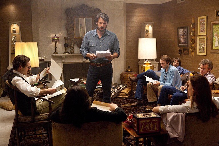 Ben Affleck (standing) stars in and directs "Argo," which tops Anita Modak-Truran's list of best 2012 films.
