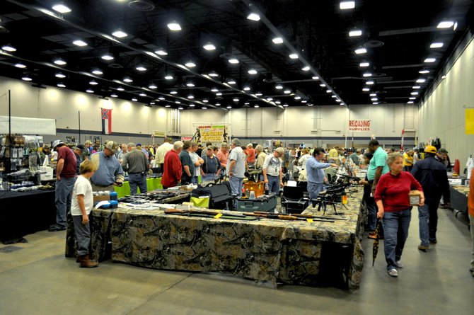 A gun vendor displays his wares to Mississippians at the Jackson Gun Show that took place Jan. 12 and 13 at the Trade Mart Building. Organizers estimated that the turnout hit record numbers; some attendees waited in line for hours just to get in.