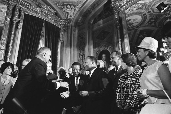 Martin Luther King Jr. meets with then-President Lyndon Johnson following the signing of the Voting Rights Act in 1965.