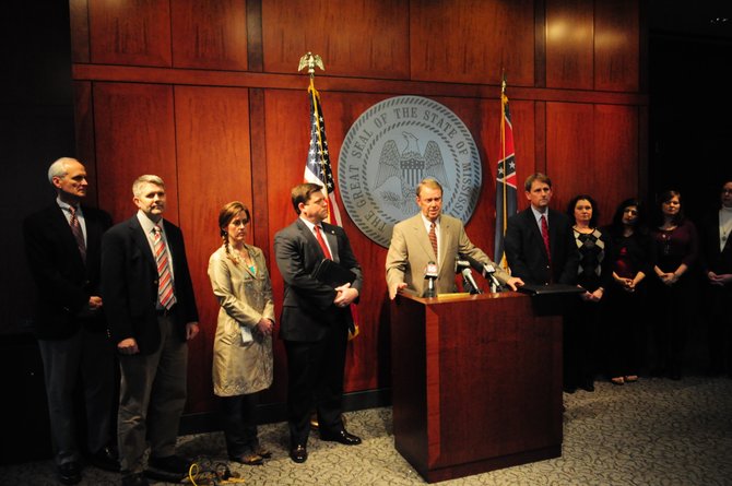 Mississippi Insurance Commissioner Mike Chaney (standing at podium), a Republican now in his second-term as insurance commissioner, started working on the Mississippi health-insurance exchange more than three years ago, before Bryant became governor.