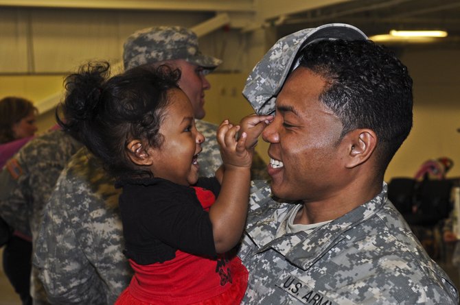 With veterans returning from wars overseas, Mississippi could be the first state to launch a program designed to assist returning veterans in rural communities. In this photo, Emma Sharee Calica greets her father, Austen Calica, in Washington state.