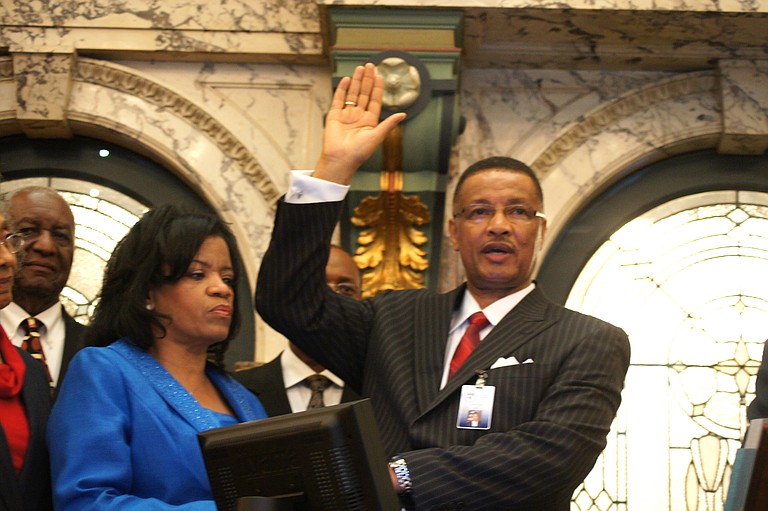 Sollie Norwood (right), with wife, Joan, looking on, is sworn in as Jackson’s newest state senator.