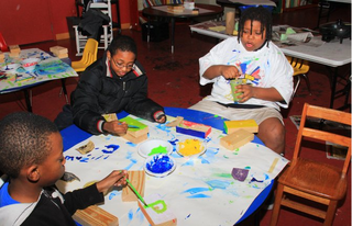 Kids at Operation Shoestring paint blocks to become part of the C3 project.