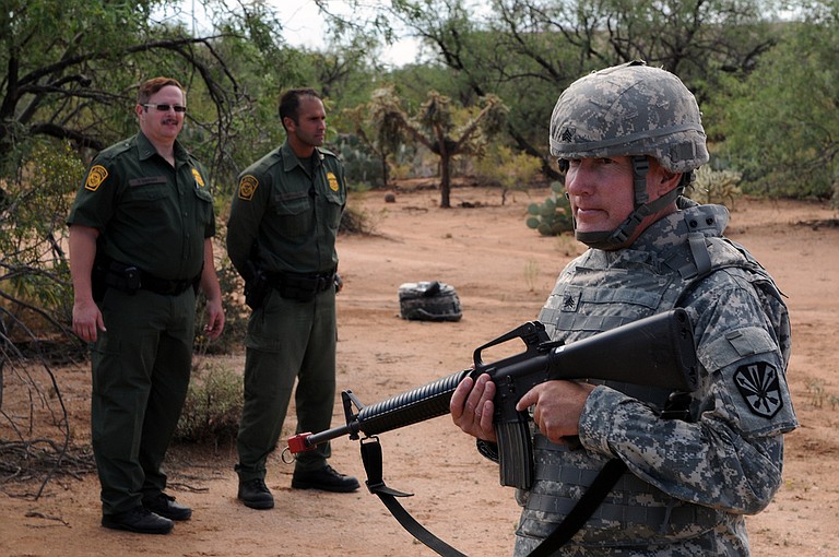 Border Patrol agents observe an Arizona National Guard Soldier training for Operation Copper Cactus at an undisclosed location in Arizona on Aug. 25, 2010. Operation Copper Condor is the Arizona National Guard's contribution to the up to 1,200 National Guard troops being deployed to support the Border Patrol and Immigration and Customs Enforcement in the four Southwest border states.