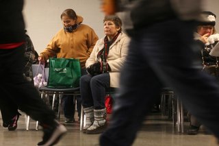 Rosa Ramirez waits to be called for a job at the temp agency Staffing Network in Hanover Park, Ill., on Jan. 21, 2013.