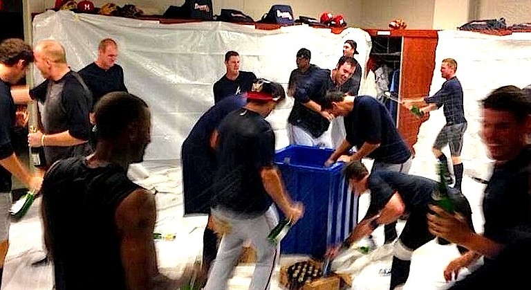 The Mississippi Braves celebrating their playoff win in the locker room.