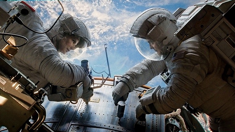 Sandra Bullock and George Clooney shine in the outer-space thrill ride “Gravity.”