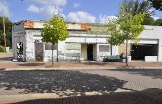 A building at the corner of Griffith and Farish streets sits abandoned, with no door or windows, rotting from the inside out.