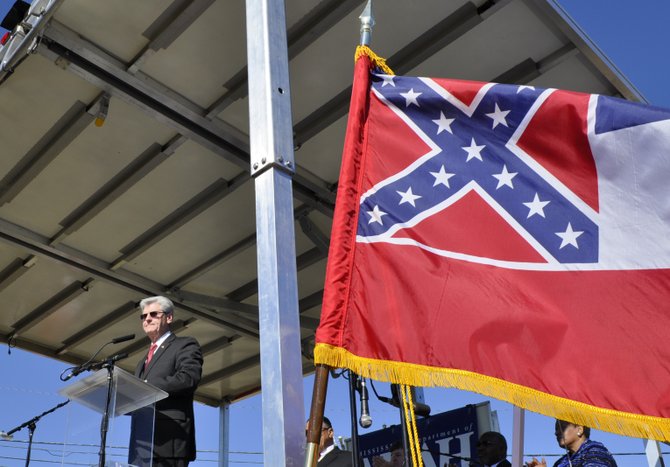 Gov. Phil Bryant spoke at the groundbreaking of Mississippi's new Civil Rights Museum next to the state flag containing the Confederate battle symbol. Myrlie Evers-Williams, the widow of slain Jackson civil-rights hero Medgar Evers, is visible below the flow.