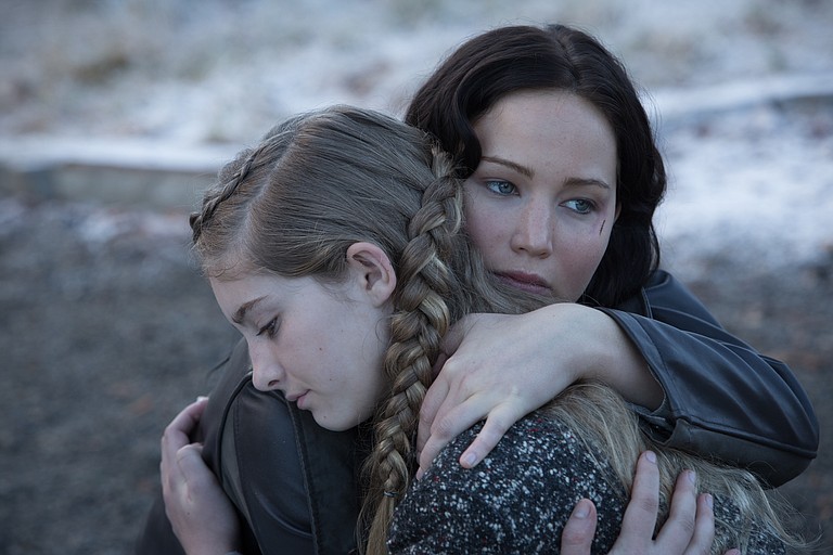 In “The Hunger Games: Catching Fire,” Katniss Everdeen (Jennifer Lawrence, right) once again finds herself fighting to save her sister Prim (Willow Shields, left).