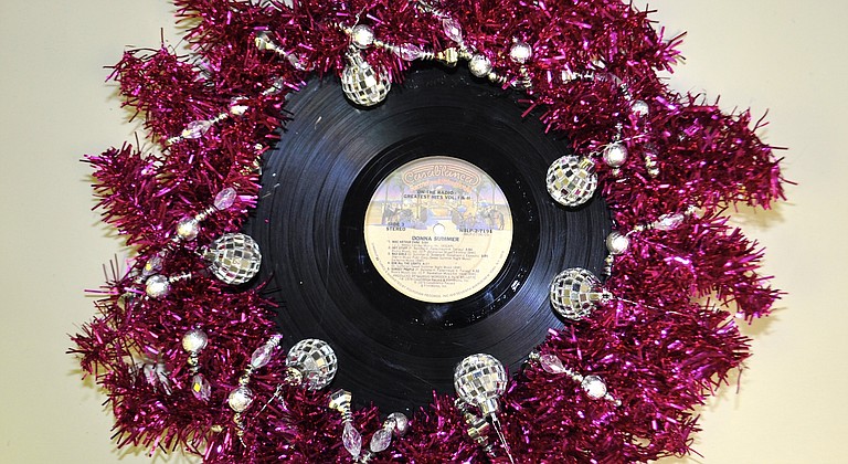 In search of the tackiest wreath I could come up, I decided to pay homage to Miss Donna Summer, Disco Queen. I glued the most scratched album I could find of hers behind a used pink wreath form, tied around a silver bead-garland and added disco-ball ornaments. Hint: Use this for inspiration to dress for the next Best of Jackson party. —D.L.
