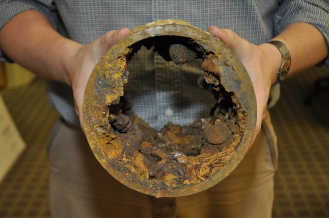 This corroded pipe, which was dug up from under West Street, is made of cast iron, and doesn’t have a protective lining like newer ductile iron pipes do.