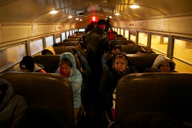 Temp workers from Chicago's Little Village board a bus bound for work on an early January morning.
