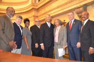 Jackson Mayor Chokwe Lumumba welcomed lawmakers and encouraged them to spend money in the capital city. Pictured, from left: Rep. Jim Evans, D-Jackson, Speaker Pro Tempore Rep. Greg Snowden, R-Meridian,  Rep. Adrienne Wooten, D-Jackson, Rep. Earle Banks, D-Jackson, Lumumba, Rep. Alyce Clarke, D-Jackson, Speaker Philip Gunn, R-Clinton and Rep. Credell Calhoun, D-Jackson.