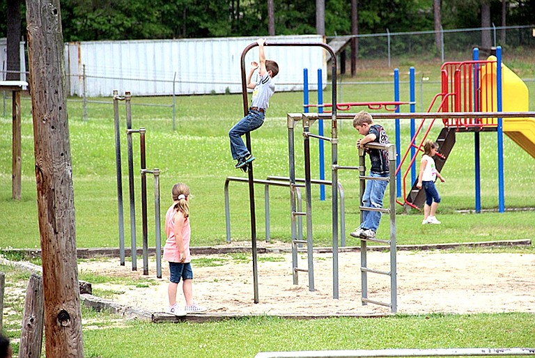 Children in the Richton School District, about 20 miles east of Hattiesburg, play on outdated playground equipment. Across Mississippi, educators say that years of underfunding have left them with inadequate facilities and few supplies.
