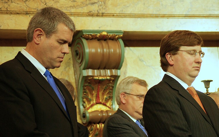 In this file photo, Mississippi Speaker Philip Gunn and Lt. Gov. Tate Reeves pray before Gov. Phil Bryant (not pictured) took the oath of office in January 2012.