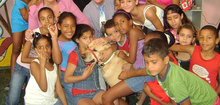 Booster in a classroom of Cuban students learning about service dogs.