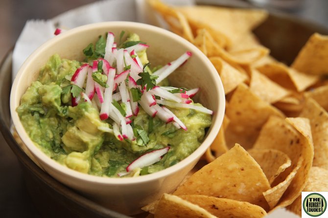 Homemade guacamole is a crowd-friendly but vegetarian option that goes great with your beer-fueled summer cookouts.