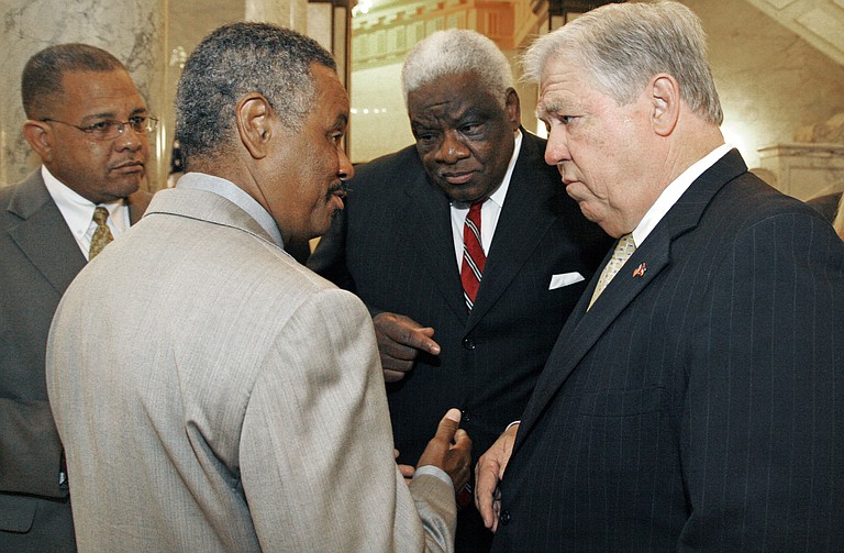 From left, Bishop Ronnie Crudup, developer Socrates Garrett and late Mississippi Development Authority official Gene McLemore attended an endorsement announcement for former Gov. Haley Barbour in 2007.