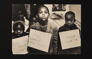 Children hold anti-poverty and voting rights signs during the Civil Rights Movement.