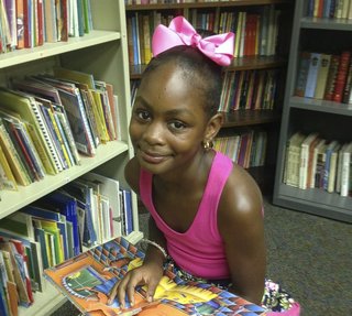 Cayden Taylor, 11, sits in the library of Operation Shoestring in Jackson.