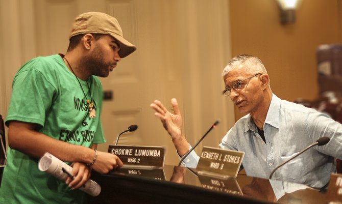 In this undated photo, then-Ward 2 Councilman Chokwe Lumumba (right) consults with his son, Chokwe Antar Lumumba, whose loss in this year’s mayoral election, some believe, stymied the economic vision his father laid out before his death.