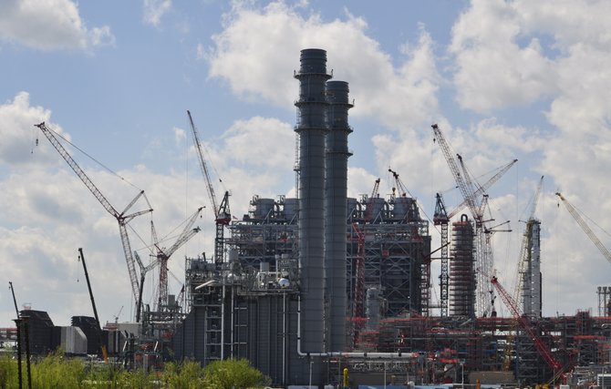 Southern Co. said Thursday that it will cost at least another $59 million to finish the power plant it's building in eastern Mississippi's Kemper County, pushing the total cost above $5.6 billion.
