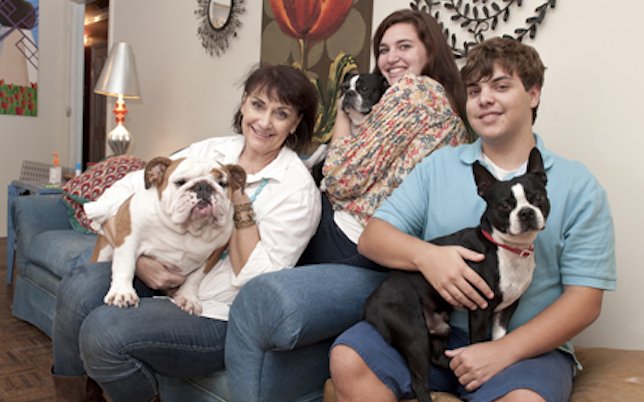Jackson resident and pancreas transplant recipient Nancy Smith, left, holding the family bulldog Crash, is all about her children: Braeden, (center), cuddling Rowdy; and Carruth, with Chaos.