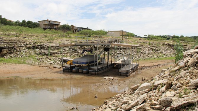 Texas Tech University professor Katharine Hayhoe works to connect events unfolding today—such as the 2012-2013 Texas drought—to climate change. Pictured is a boat stranded in Lake Travis, Texas, as waters recede in May, 2013.