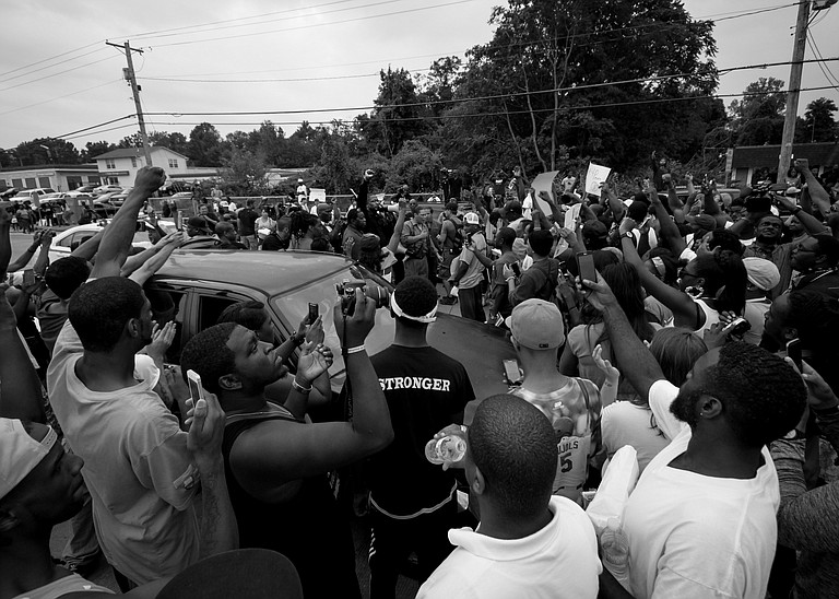 People protesting the Ferguson, Missouri, grand jury decision took to the streets in cities across the U.S. for a second day Tuesday, showing that the racially charged case has inflamed tensions thousands of miles from the predominantly black St. Louis suburb.