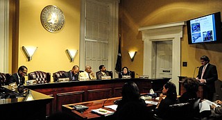 Mark Inbody of Siemens and Mitch King (pictured speaking at podium) with sub-contractor Garrett Enterprises ECI—the firm founded by businessman Socrates Garrett, who is now retired—fielded questions from the council. The representatives said that so far, 27,238 residential and 778 commercial meters have been installed.