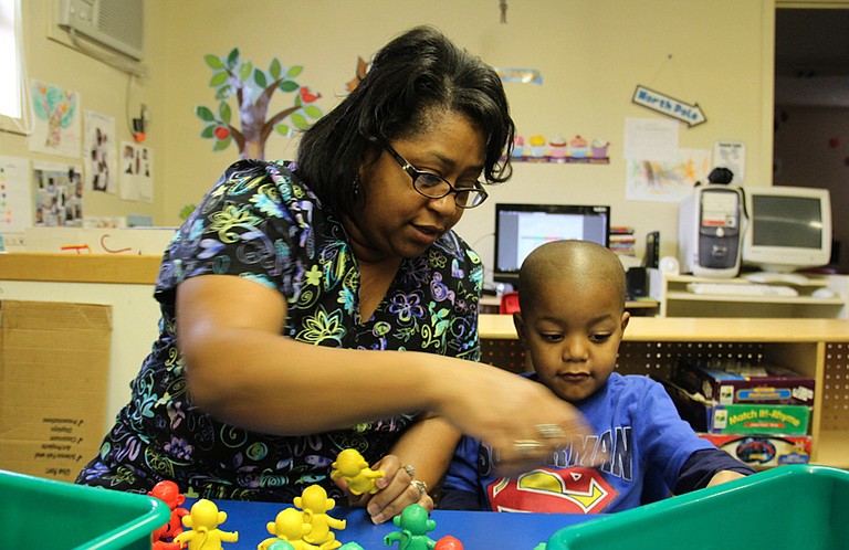 Jennifer Calvert, director of the ABC Pre-School & Nursery Inc. in Aberdeen, Miss., helps a student build a pattern during a morning activity earlier this year. Educators say early education is critical to fix Mississippi’s education deficiencies. Photo courtesy Jackie Mader