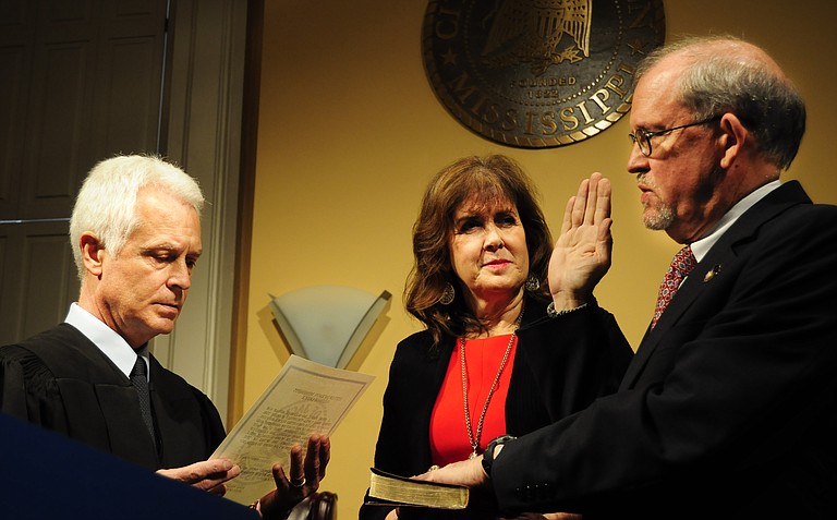 Ashby Foote (right) with his wife, Suzie Foote (center), taking the oath from Hinds County Chancery Judge Bill Singletary (left).